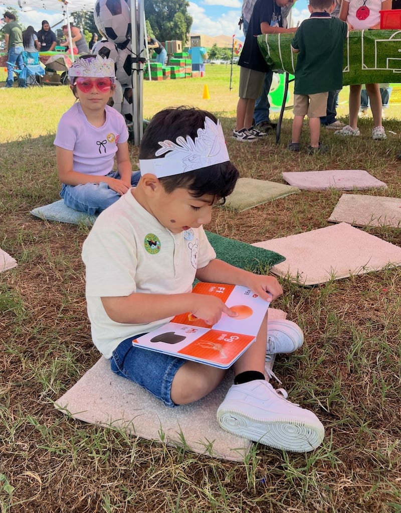 A child reads a book at the Porterville Celebrates Reading 25th anniversary event in Porterville, California, Saturday, April 11, 2026.