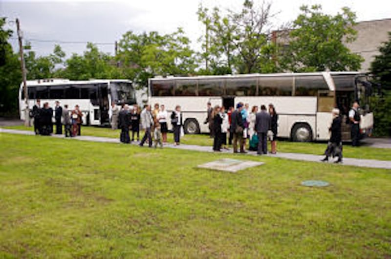 Chartered buses bring Hungarian members to Budapest to witness creation of the nation's first stake.