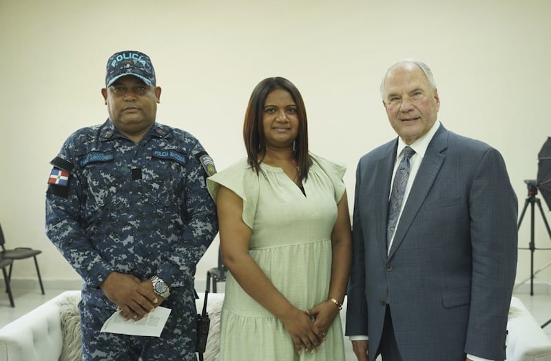 Elder Ronald A. Rasband of the Quorum of the Twelve Apostles stands with Pablo Arredondo and Erika Nieves.