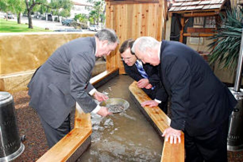 Elder Richard G. Hinckley pans for gold while Mark Lusvardi, behind, and Stephen Allen of Missionary
