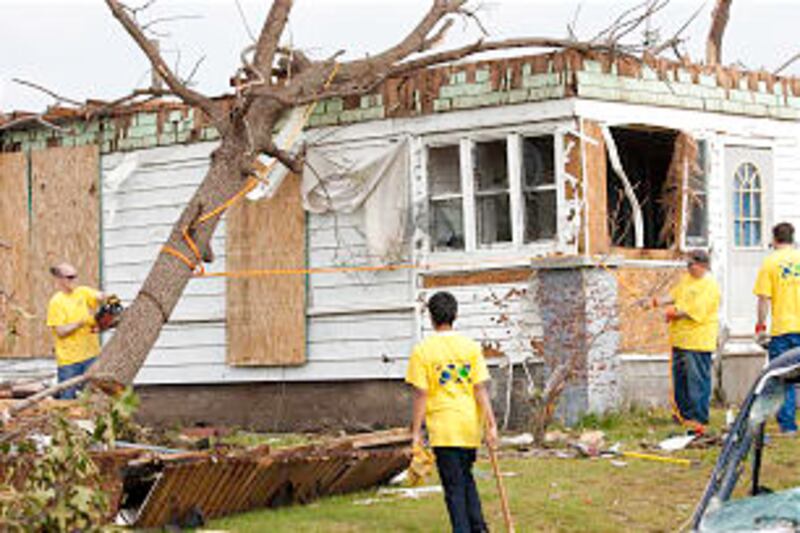 Church members wearing helping hands shirts volunteer time and effort after devastating tornado dest