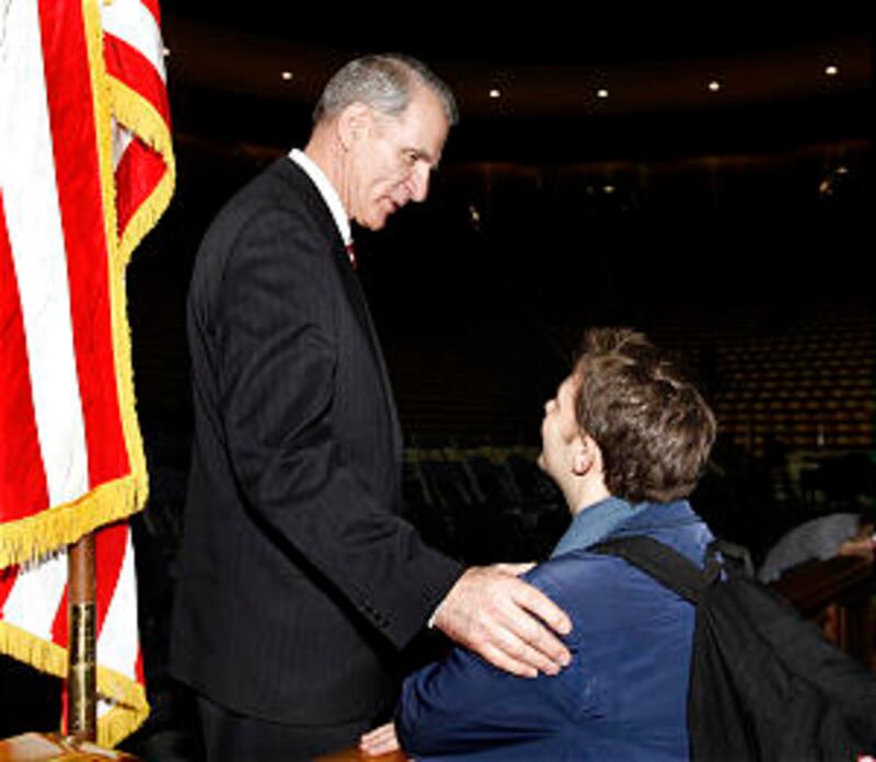 Elder Jay E. Jensen of the Presidency of the Seventy greets BYU student Bryce Isaacson following a d
