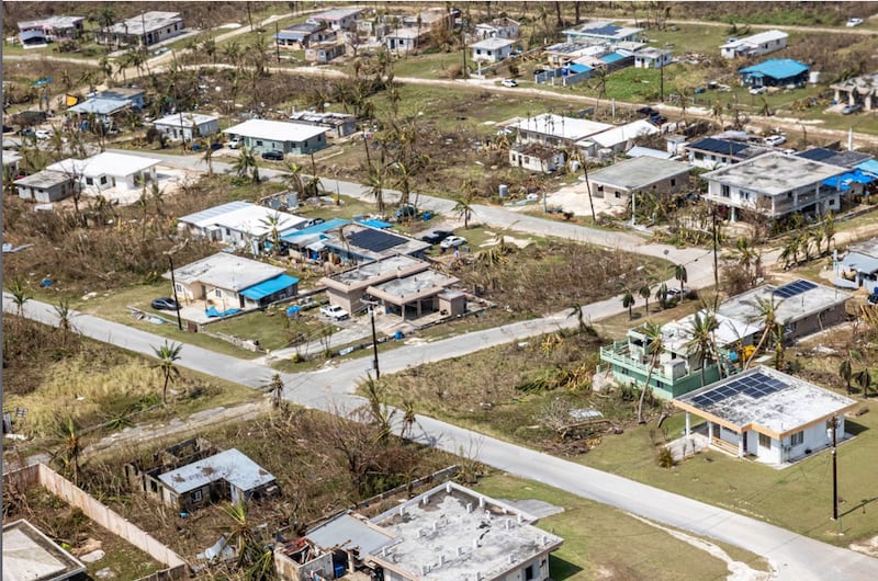 This photo provided by U.S. Marine Corps, debris covers homes and streets following Super Typhoon Sinlaku on the island of Saipan, April 18, 2026.