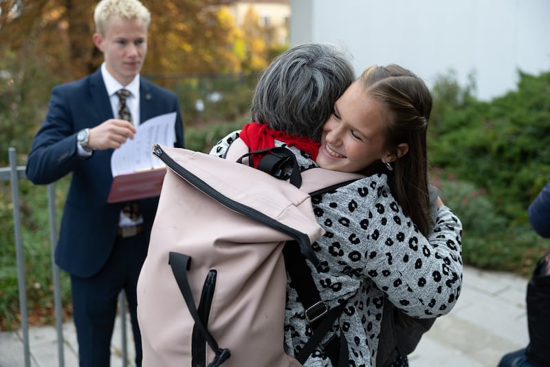 Two attendees embrace during the Vienna Austria Temple groundbreaking in Vienna, Austria, on Oct. 17, 2026.