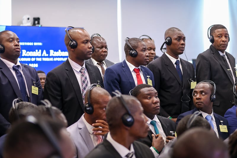 Latter-day Saints use headphones to listen to Elder Ronald A. Rasband of the Quorum of the Twelve Apostles and other Church leaders in their own language during a priesthood meeting in the border city of Dajabón, Dominican Republic, on Sept. 11, 2026.