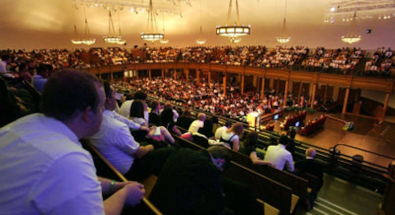 The audience listens to Bishop Gerald Causse, first counselor r in the Presiding Bishopric, as he sp