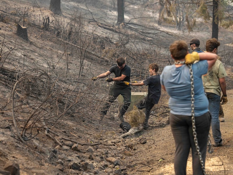 Young men and leaders from the Spokane Washington Mount Spokane Stake help clear debris from a neighborhood damaged by wildfires in Spokane, Washington, on Monday, Aug. 3, 2026.