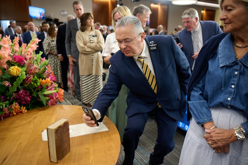 A new mission leader takes a photo of an 1830 first edition copy of the Book of Mormon at the 2026 Seminar for New Mission Leaders at the Provo Missionary Training Center in Provo, Utah, on Friday, June 19, 2026.