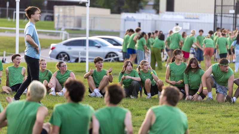 Youth sit and stand on a field at the beginning of an activity at FSY in Calgary, Alberta, Canada, in July 2026.