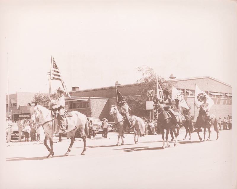 Horse riders holding flags participate in the Rexburg, Idaho, Fourth of July Parade on July 3, 1976.