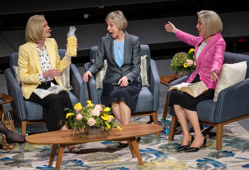 Sister Bonnie H. Cordon, Young Women general president; holds a bag of popcorn before giving it to Sister Joy D. Jones, Primary general president, who reacts to the gift as Sister Jean B. Bingham, Relief Society general president, reacts as well during a “Sister to Sister” event at Women’s Conference at BYU’s Marriott Center in Provo, Utah, on Friday, May 3, 2019.