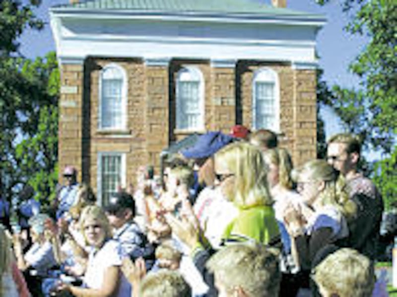 On grounds of old capitol in Fillmore, audience applauds for President Gordon B. Hinckley.