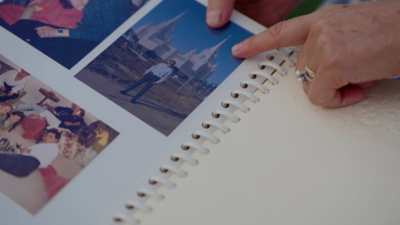Elizabeth and Giovanni Guanuna show wedding pictures on the grounds of the San Diego California Temple.