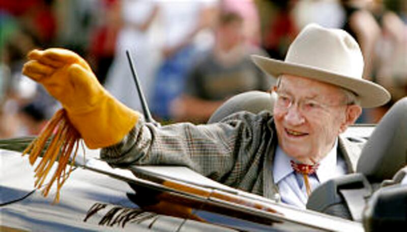 President Gordon B. Hinckley waves as he is driven during the Days of '47 parade Tuesday, July 24, 2