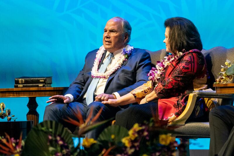 Elder Ronald A. Rasband of the Quorum of the Twelve Apostles, left, speaks and Sister Melanie T. Rasband, right, listens during the young adult devotional for Pacific and Asia areas at the Salt Lake Tabernacle on Temple Square on Saturday, March 13, 2021.
