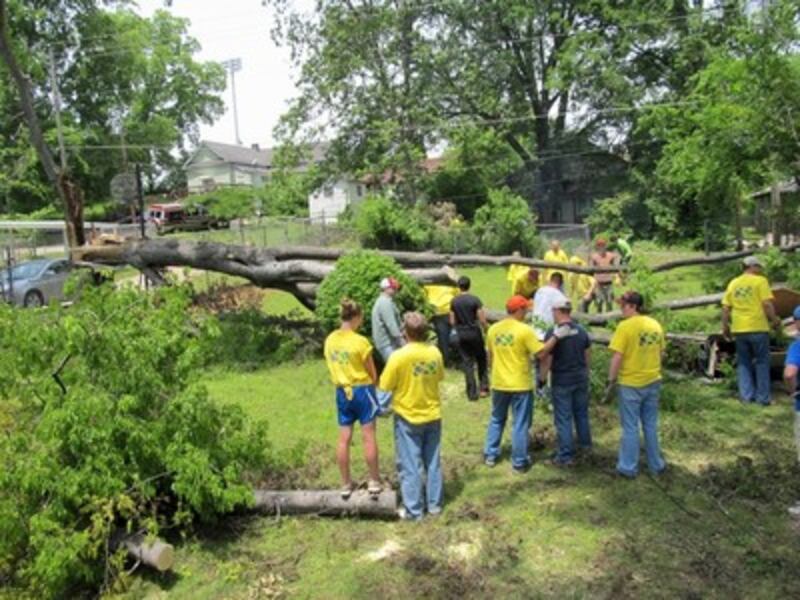 Volunteers work in Ms. Collins' yard.