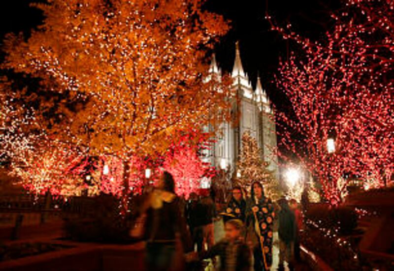 Downtown visitors walk through the Main Street Plaza as Christmas lights are turned on downtown an