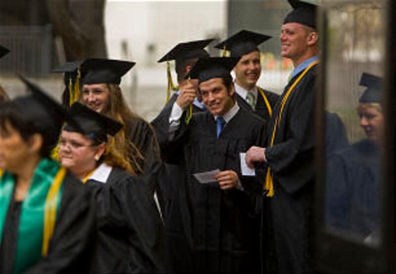 Gonzo Pastorini waits in line with other members of the LDS Business College Class of 2011 outside o