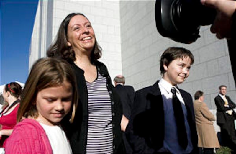 Terrie Hotvodt, center talks to the media about her children Katherine, 7, left, and Christoffer, 13