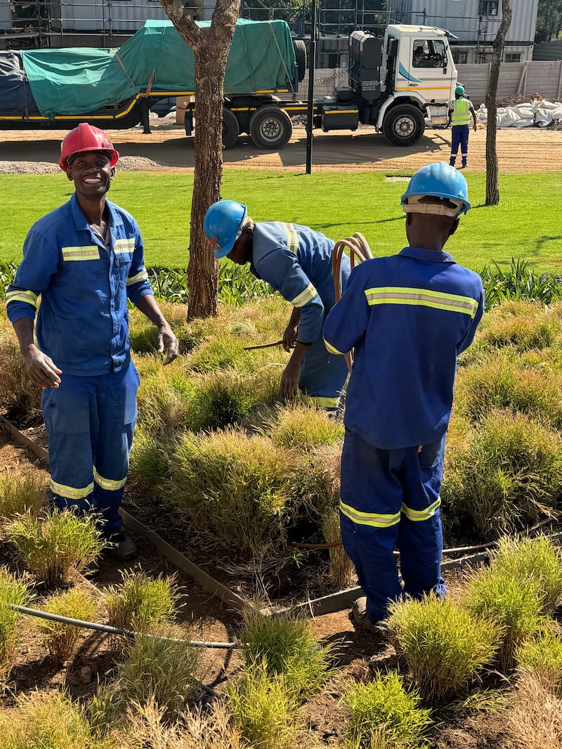 Kilford Shereni, left, works on the irrigation system for the Harare Zimbabwe Temple.