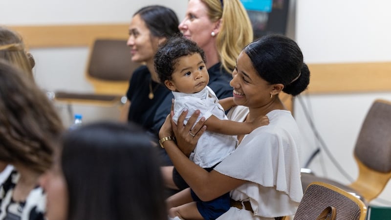 A mother holds her child during a devotional in Larnaca, Cyprus, on Sept. 2, 2026.
