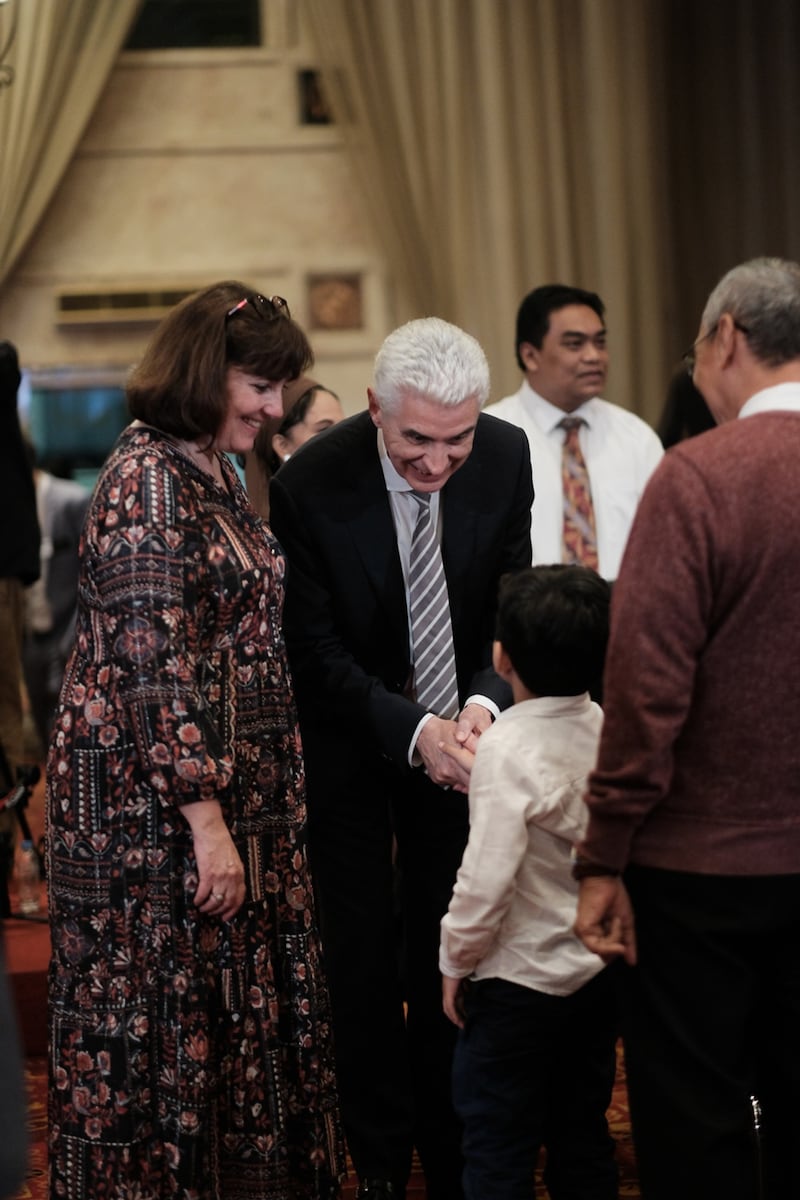 Elder Gérald Caussé of the Quorum of the Twelve Apostles and Sister Valérie Caussé greet a young member before the member devotional in Jakarta, Indonesia, on April 21, 2026.