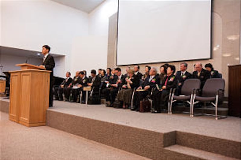 Speakers and former mission presidents on the stand at the 50th anniversary celebration of establish