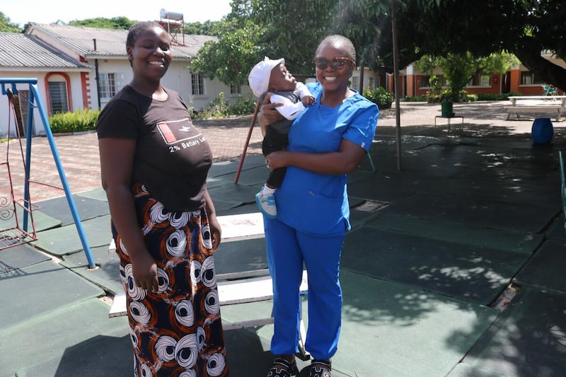 A one-year-old baby is reunited with a NICU staff member outside the Lewanika General Hospital in Mongu, Zambia. Baby Samuel was born premature in December 2024.