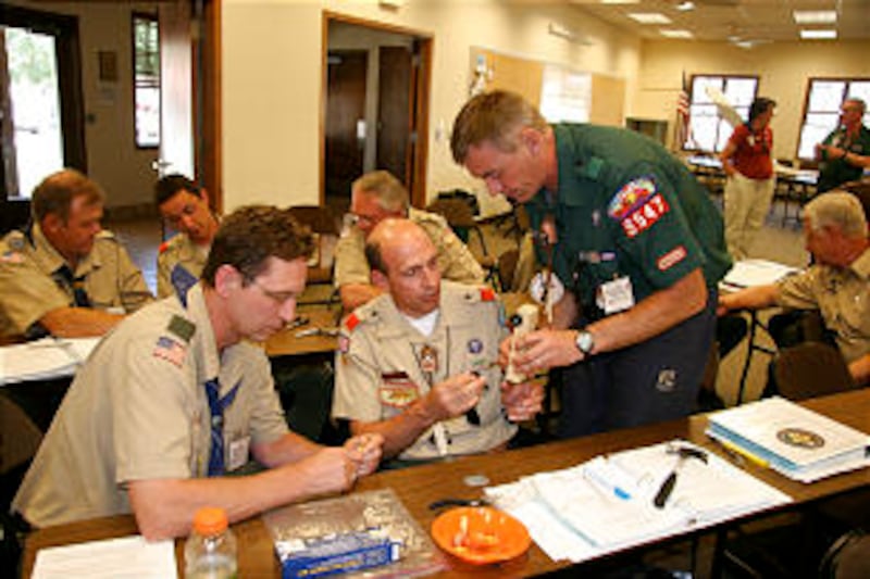 Douglas Foster, left, works on a pinewood car with David Harding and Bradley Porter during Cub Scout