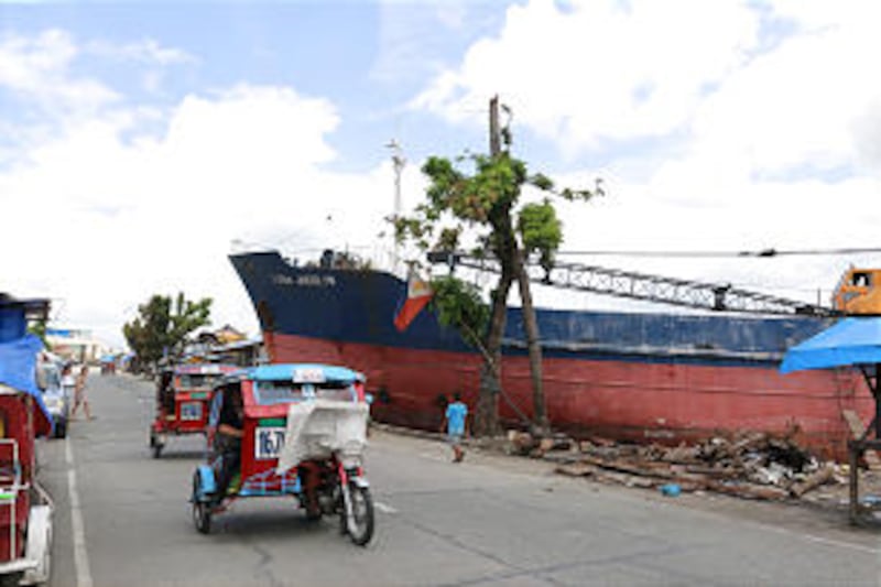 Four months after Typhoon Haiyan struck central Philippines on Nov. 8, a boat washed ashore stands i