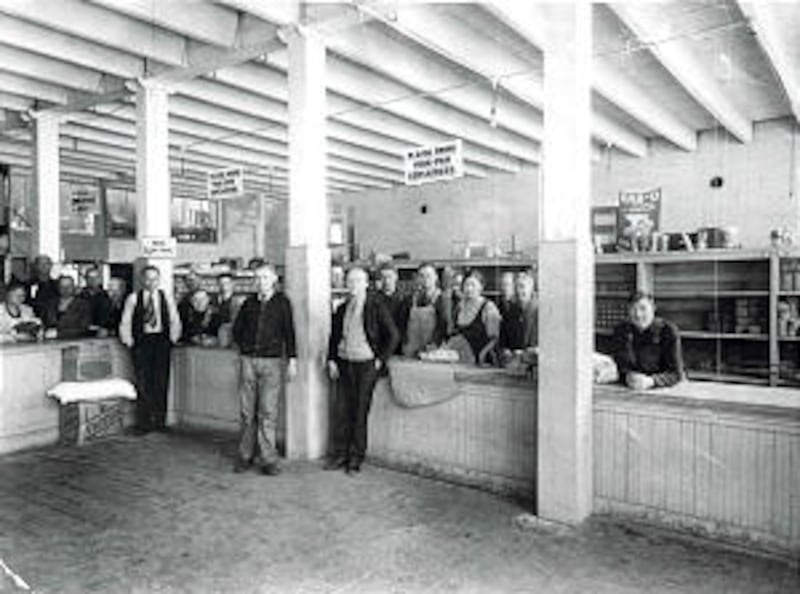 Inside Pioneer Stake bishops' storehouse in 1932 is Bishop Jesse M. Drury, Alfons J. Finck, and Phil