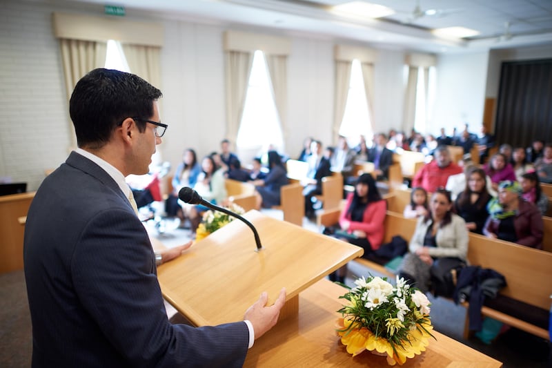 A young man speaks to the congregation in sacrament meeting.