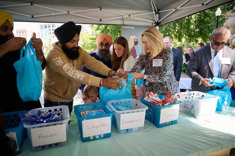 President Camille N. Johnson and members of various faith traditions package welcome bags for domestic violence survivors at Indy Festival of Faiths in Indianapolis, Indiana.