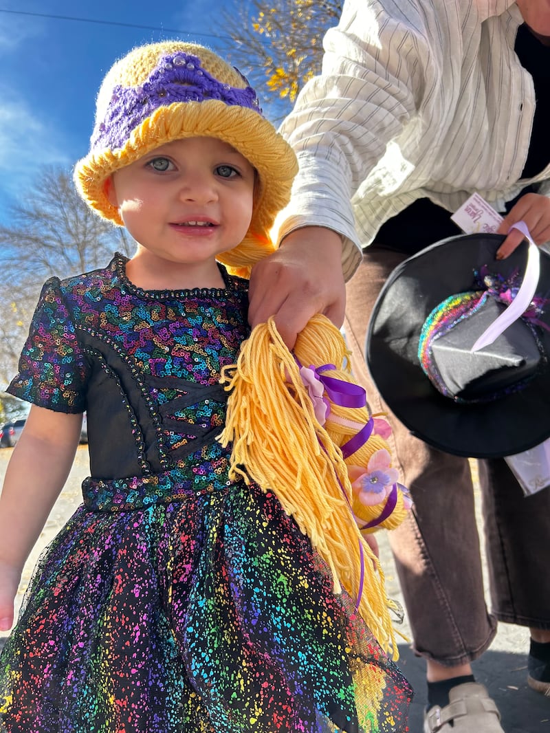 Rossi Holliday, a 2-year-old girl who finished cancer treatments in May 2025, wears a wig she received from the Magic Yarn project in Blanding, Utah, Oct. 25, 2025.