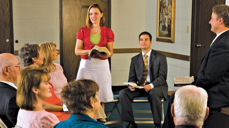A group of adults discusses the scriptures during a gospel doctrine class.