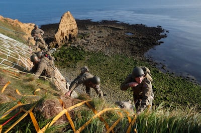 Soldiers from the U.S. 75th Ranger Regiment, in period dress, climb the cliff of Pointe-du-Hoc in Cricqueville-en-Bessin, Normandy, France, Wednesday, June 5, 2019. During the American assault of Omaha and Utah beaches on June 6, 1944, U.S. Army Rangers scaled the 100-foot cliffs to seize German artillery pieces that could have fired on the American landing troops.