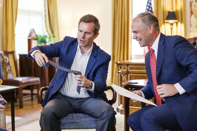 Elder Nathan A. Craig, an Area Seventy who will begin serving as a mission leader in July 2026, right, receives a Kentucky-themed tie from Kentucky Gov. Andy Beshear, left, on March 10, 2026.
