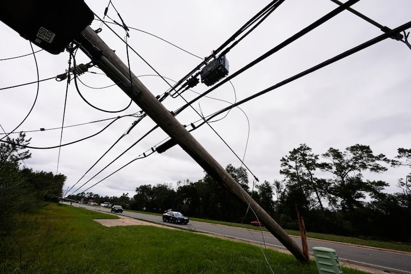 State troopers ride past downed power lines in the aftermath of Hurricane Isaias in Milton, Florida, Saturday, Oct. 10, 2026.