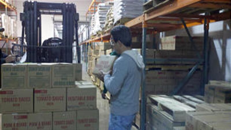 Troy Bennett, a member of the Dunwoody Ward, Atlanta Georgia Stake, loads cases of food and commodit