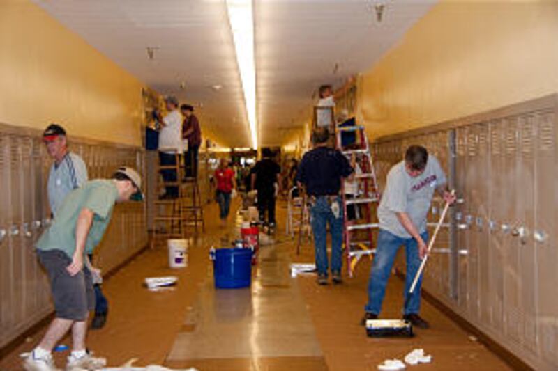 Church members clean walls and hallways of Jefferson High School.