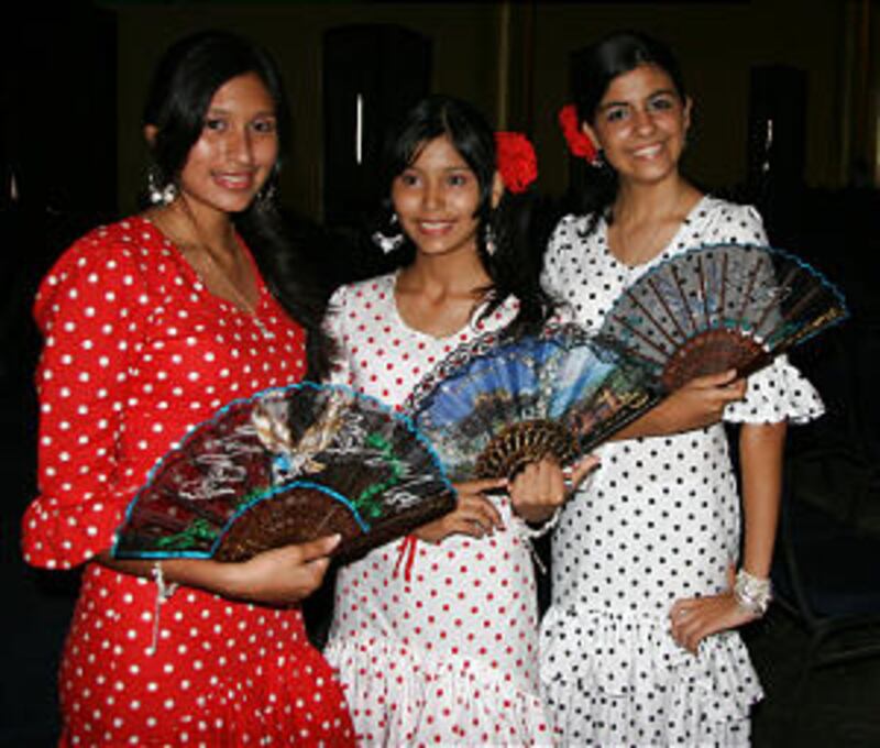 Fan-waving young women prepare to take the stage for the flamenco.