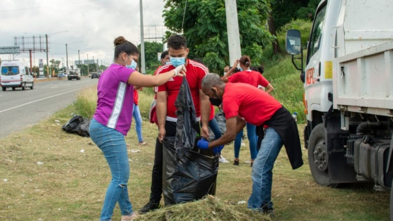 A group of Latter-day Saints in Pedro Brand, Dominican Republic, fills a bag with waste gathered around the city in December 2020.