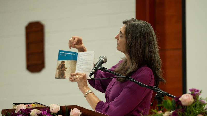 Sister Andrea Muñoz Spannaus shows the updated "For the Strength of Youth" guide in Antananarivo, Madagascar, Aug. 29, 2026.