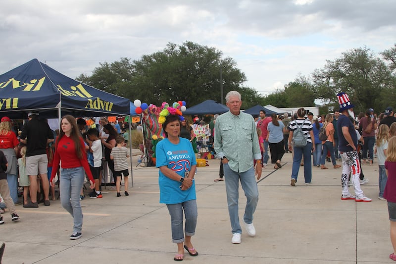 Attendees walk around to the different booths and activities at the "Fiesta 2026" event in San Antonio, Texas, on April 11, 2026.