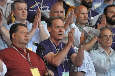 Members of the San Francisco Gay Men’s Chorus, clad in purple T-shirts, sing with the Mormon Tabernacle Choir during the June 27 sound check prior to the choir’s concert in Mountain View, California.