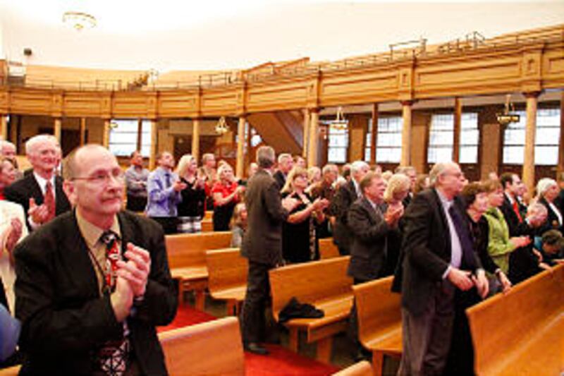 Audience applauds after performances by three organists.