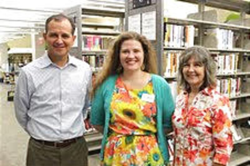 Craig Norman, and his wife, Tussy Norman, with Laura Smith, center, a librarian at Clear Lake's Free