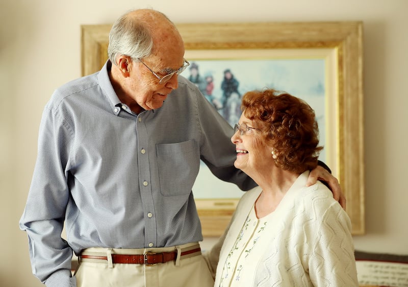 Jim and Colleen Pinegar stand and look at each other at their home in Orem on Tuesday, Aug. 7, 2018