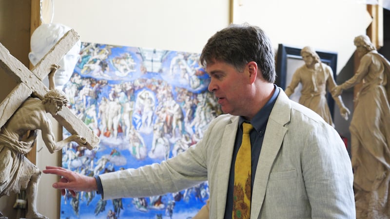 Sculptor Michael Hall shows one of his sculptures at his studio in Provo, Utah.