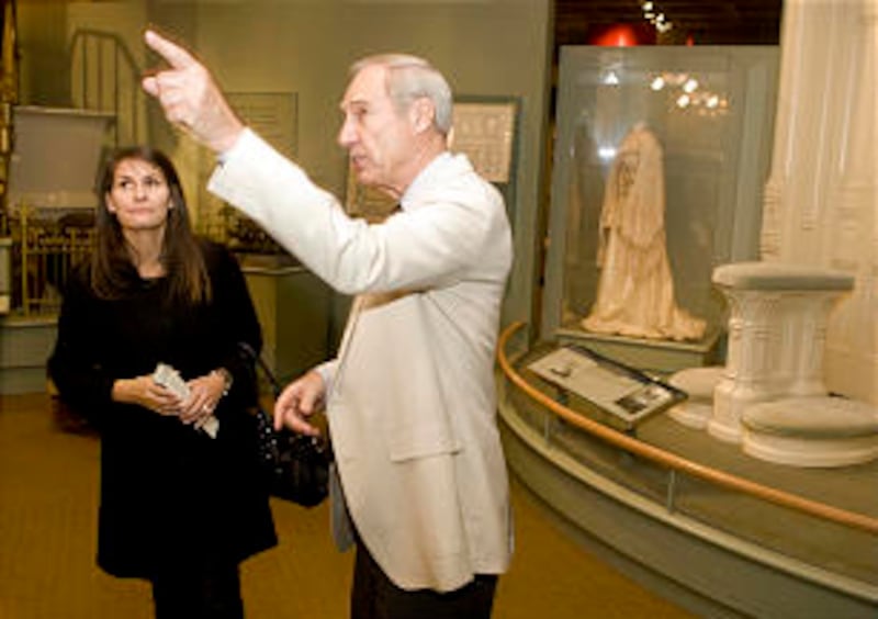 A docent points out some interesting items in the museum.